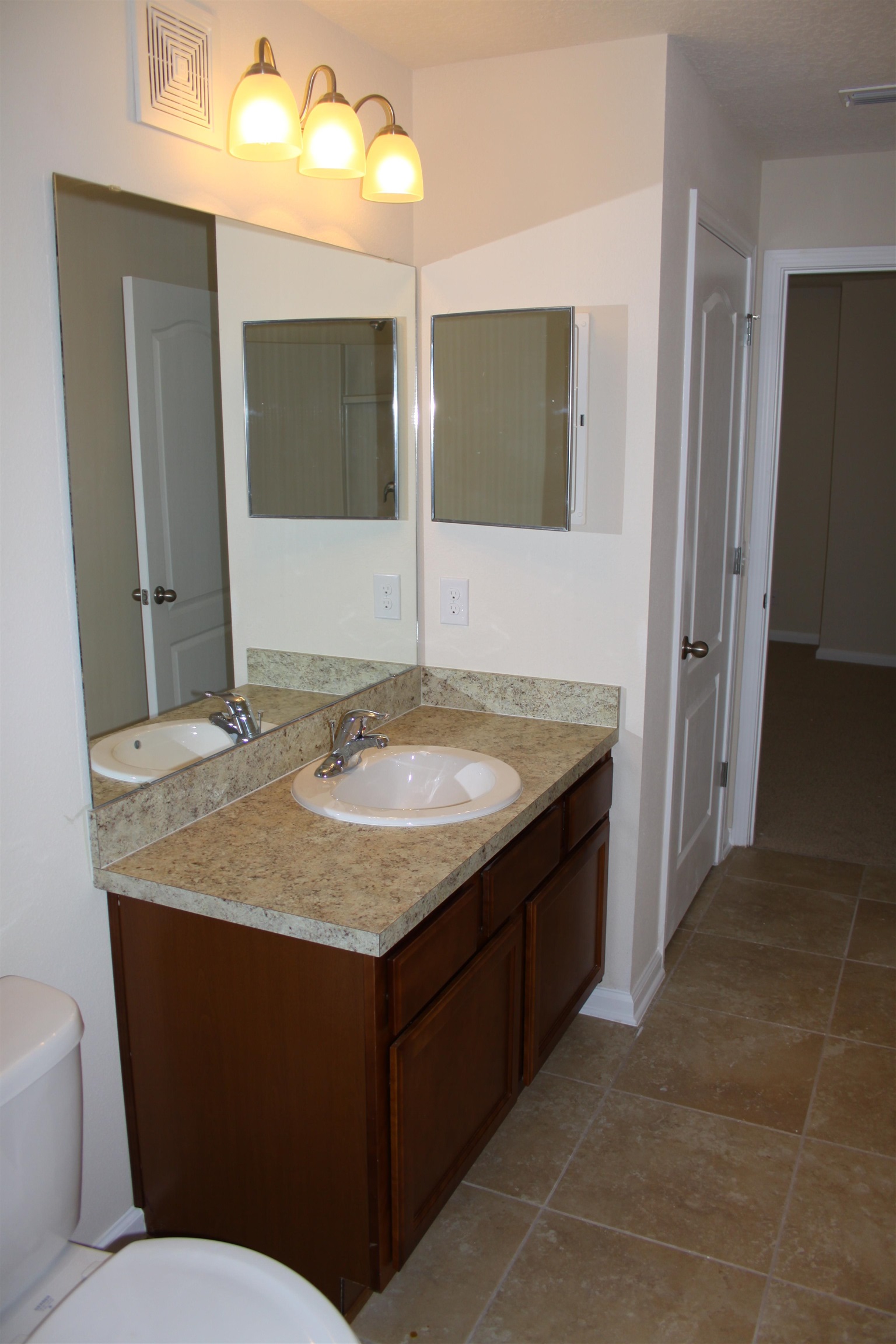 811 Golden Lake Loop St. Augustine, FL 32084 - Photo 12 of 20 a bathroom with a granite countertop sink and a mirror