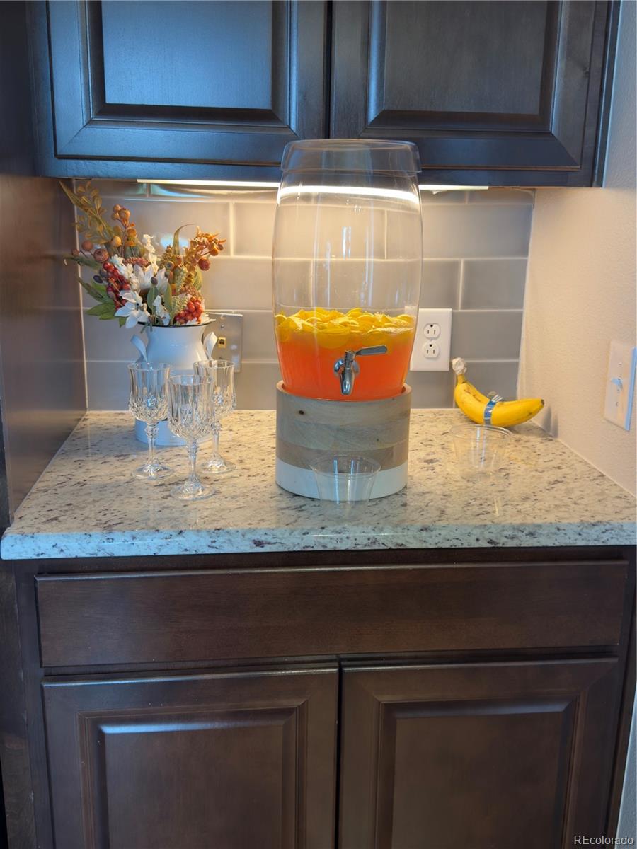 5825 Wilson Road Colorado Springs, CO 80919 - Photo 14 of 50 a kitchen with granite countertop wooden cabinets and a counter top