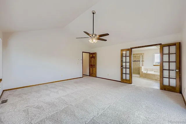 a view of an empty room with a ceiling fan