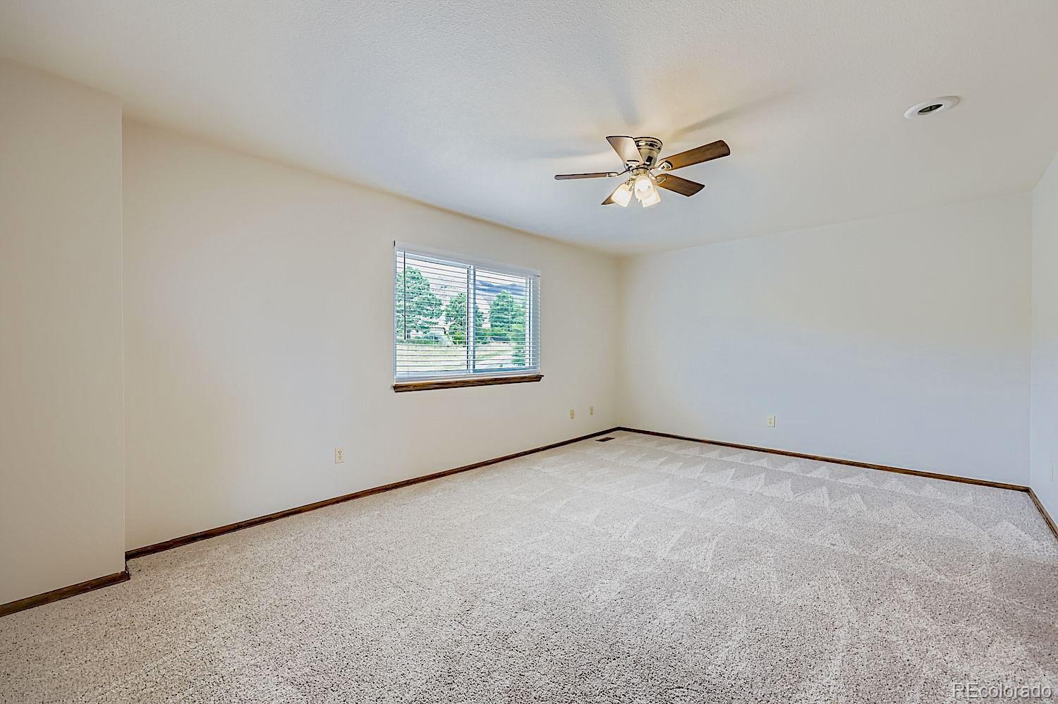 5825 Wilson Road Colorado Springs, CO 80919 - Photo 25 of 50 an empty room with windows and ceiling fan