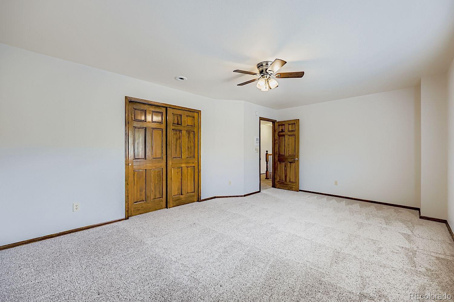 5825 Wilson Road Colorado Springs, CO 80919 - Photo 27 of 50 a view of an empty room with a ceiling fan