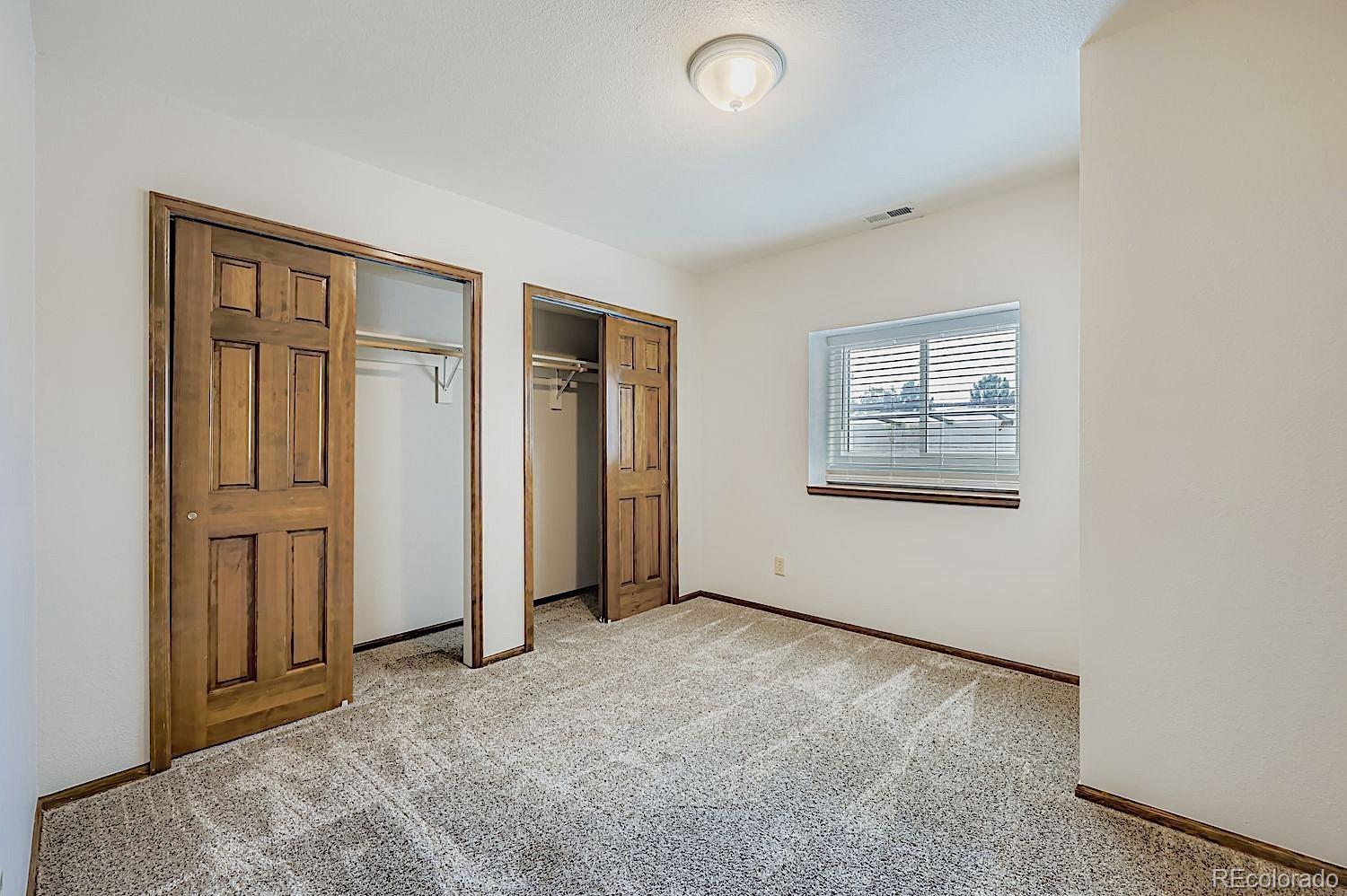 5825 Wilson Road Colorado Springs, CO 80919 - Photo 36 of 50 an empty room with windows and closet