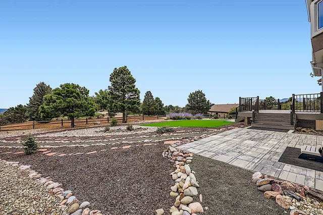 a view of a garden with a house