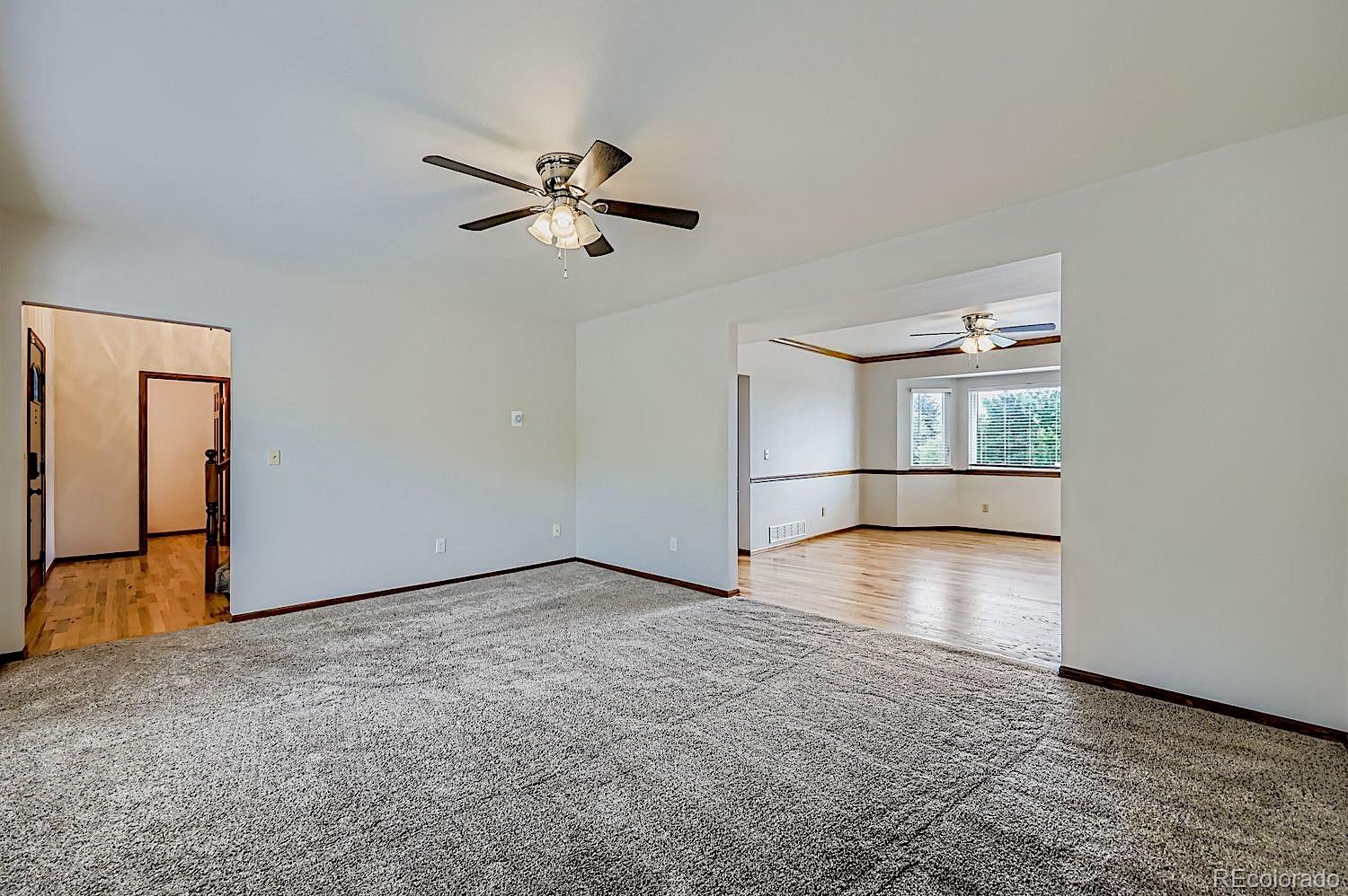 5825 Wilson Road Colorado Springs, CO 80919 - Photo 7 of 50 a view of empty room with wooden floor and fan