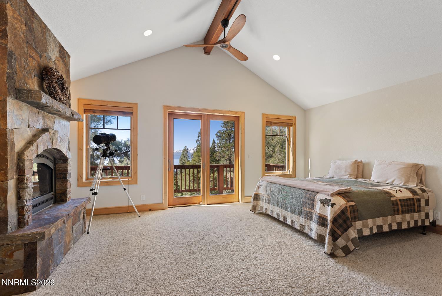 38 South Point Place Glenbrook, NV 89413 - Photo 13 of 24 a spacious bedroom with a large bed and a fireplace