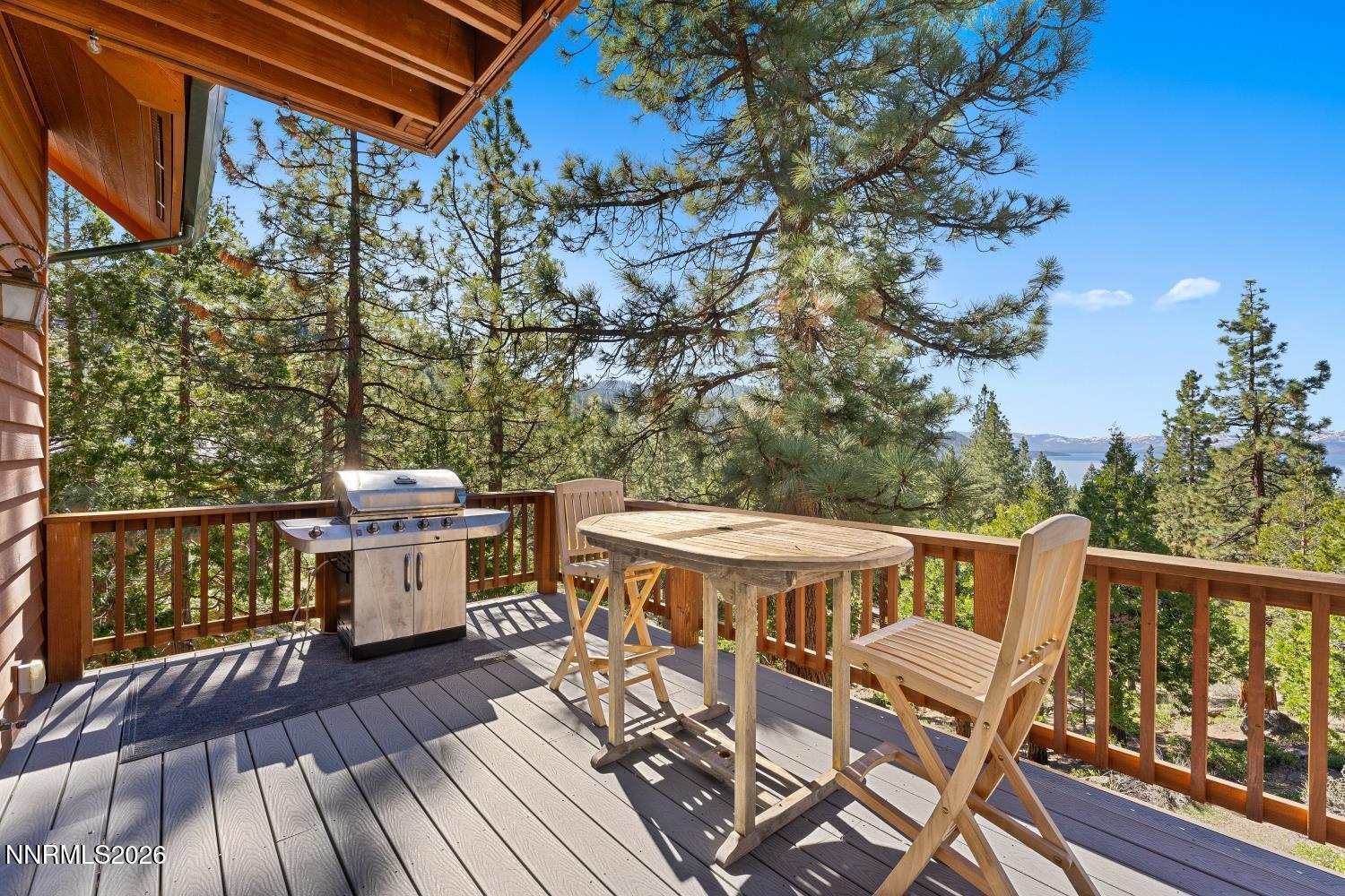 38 South Point Place Glenbrook, NV 89413 - Photo 4 of 24 a view of a patio with table and chairs a barbeque with wooden floor and fence