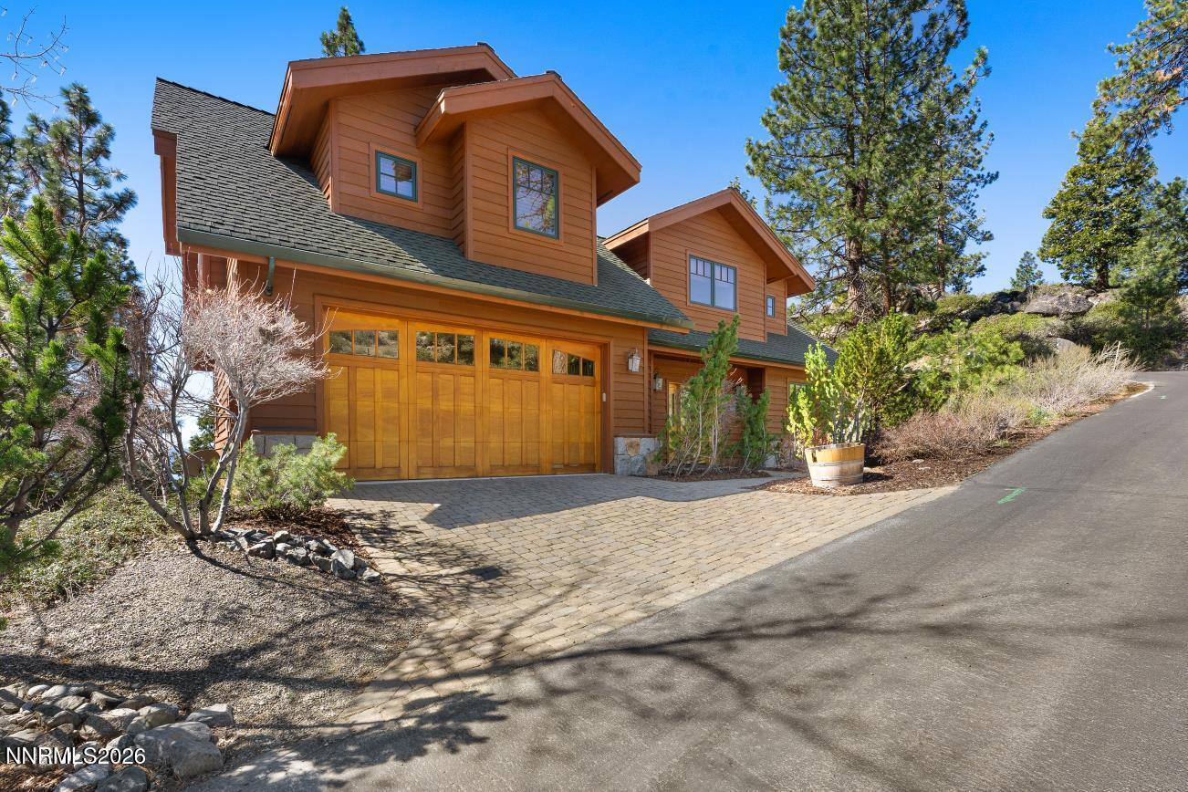 38 South Point Place Glenbrook, NV 89413 - Photo 7 of 24 a front view of a house with a yard and garage