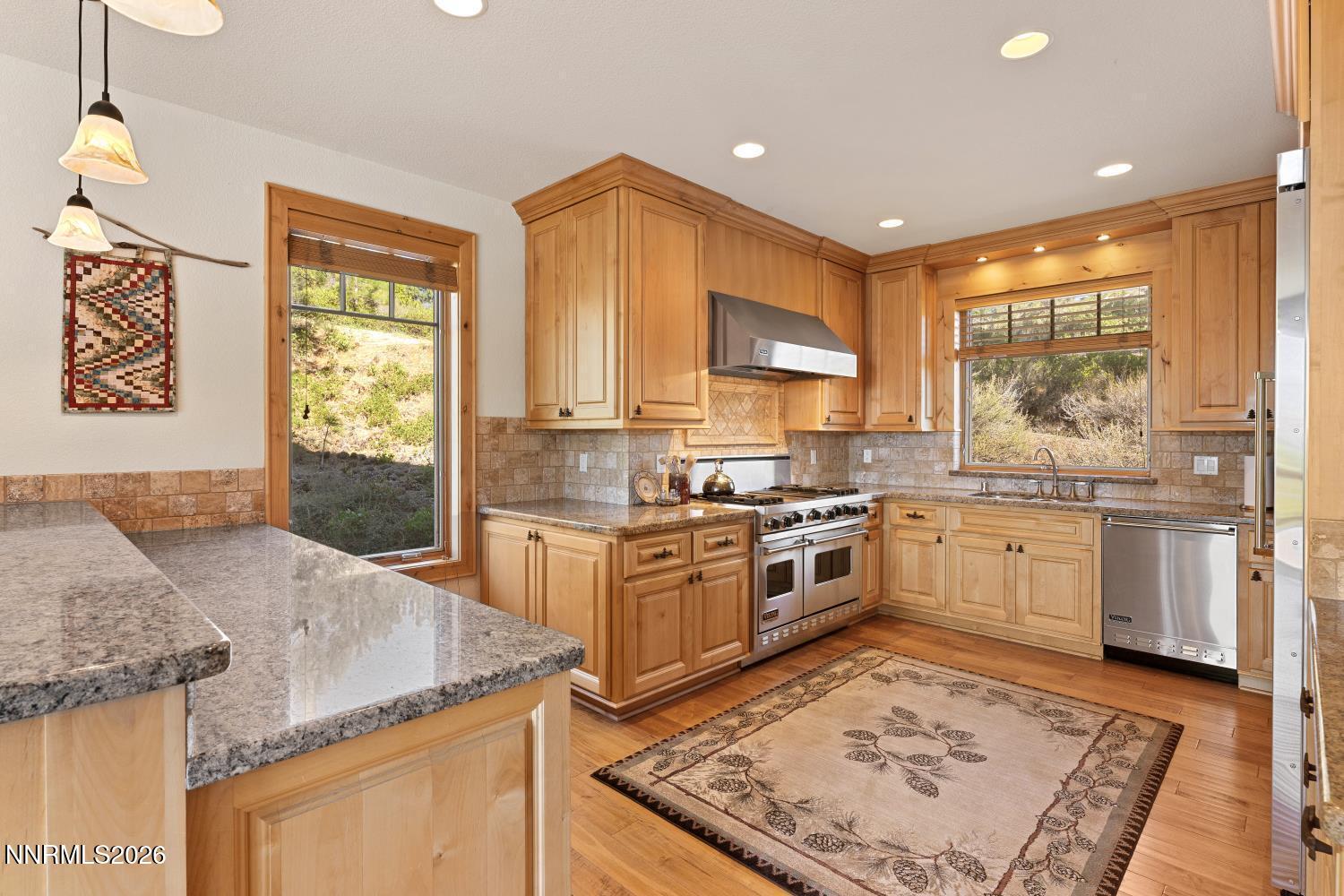 38 South Point Place Glenbrook, NV 89413 - Photo 8 of 24 a kitchen with granite countertop a stove a sink and a refrigerator
