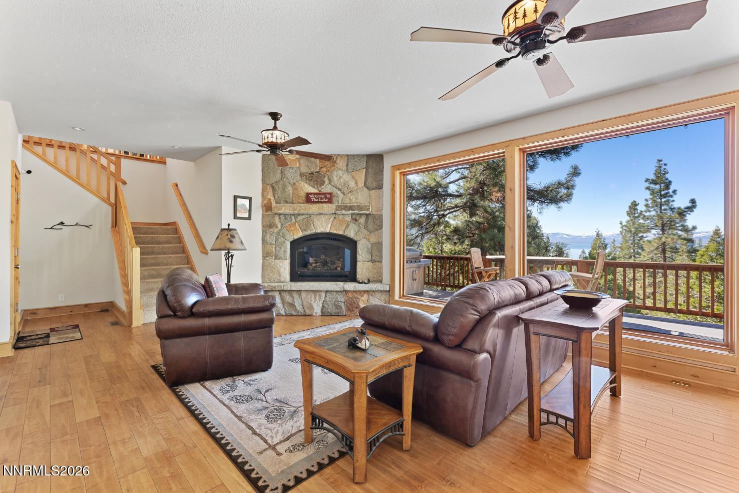 38 South Point Place Glenbrook, NV 89413 - Photo 10 of 24 a living room with furniture a fireplace and a floor to ceiling window