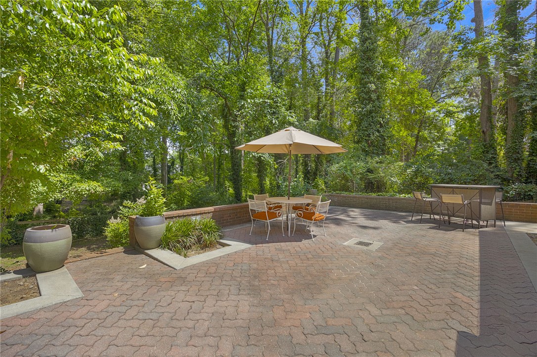 218 Northridge Drive Anderson, SC 29621 - Photo 40 of 50 A private, brick-paved patio offers ample space for outdoor enjoyment amidst a serene, wooded backdrop.