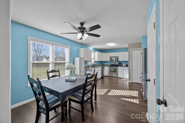 a view of a dining room with furniture and a window