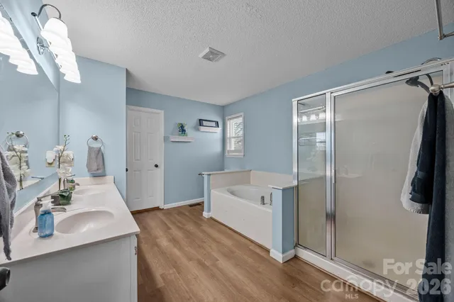 a spacious bathroom with a double vanity sink and a mirror