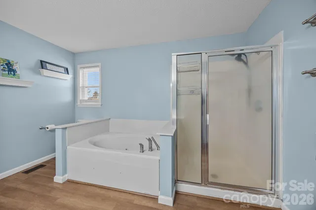 a view of walk in closet with clothes