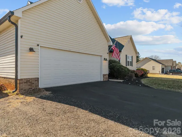 a view of a porch with chairs and potted plants