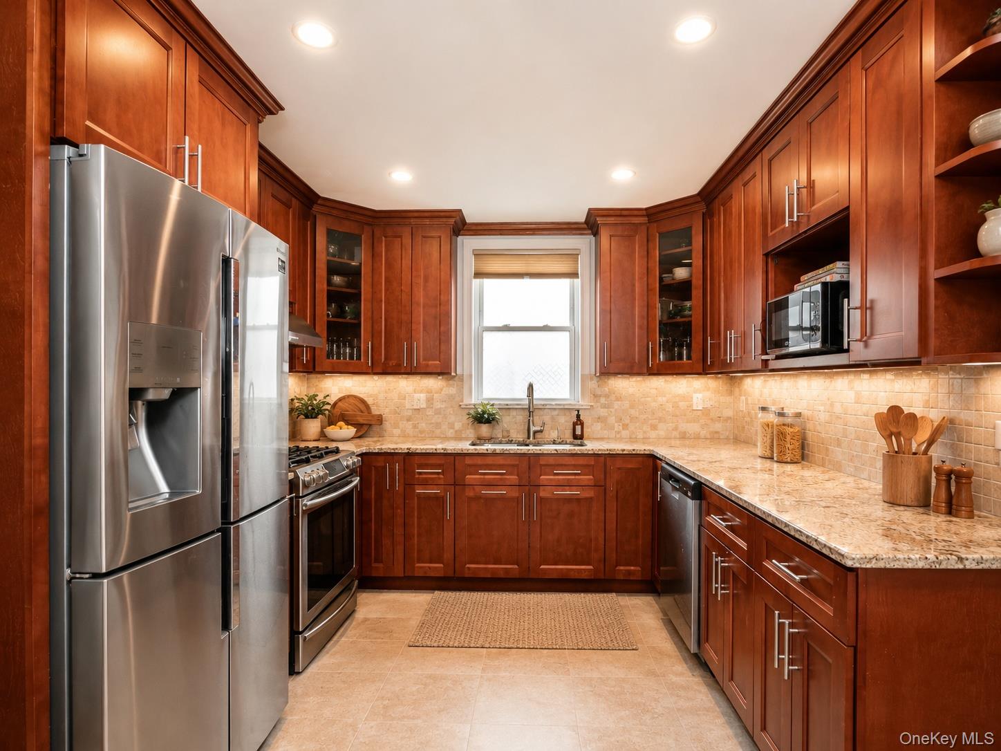 45-32 Westminster Road Great Neck, NY 11020 - Photo 7 of 21 a kitchen with stainless steel appliances granite countertop a refrigerator a sink a stove a washer dryer and a refrigerator