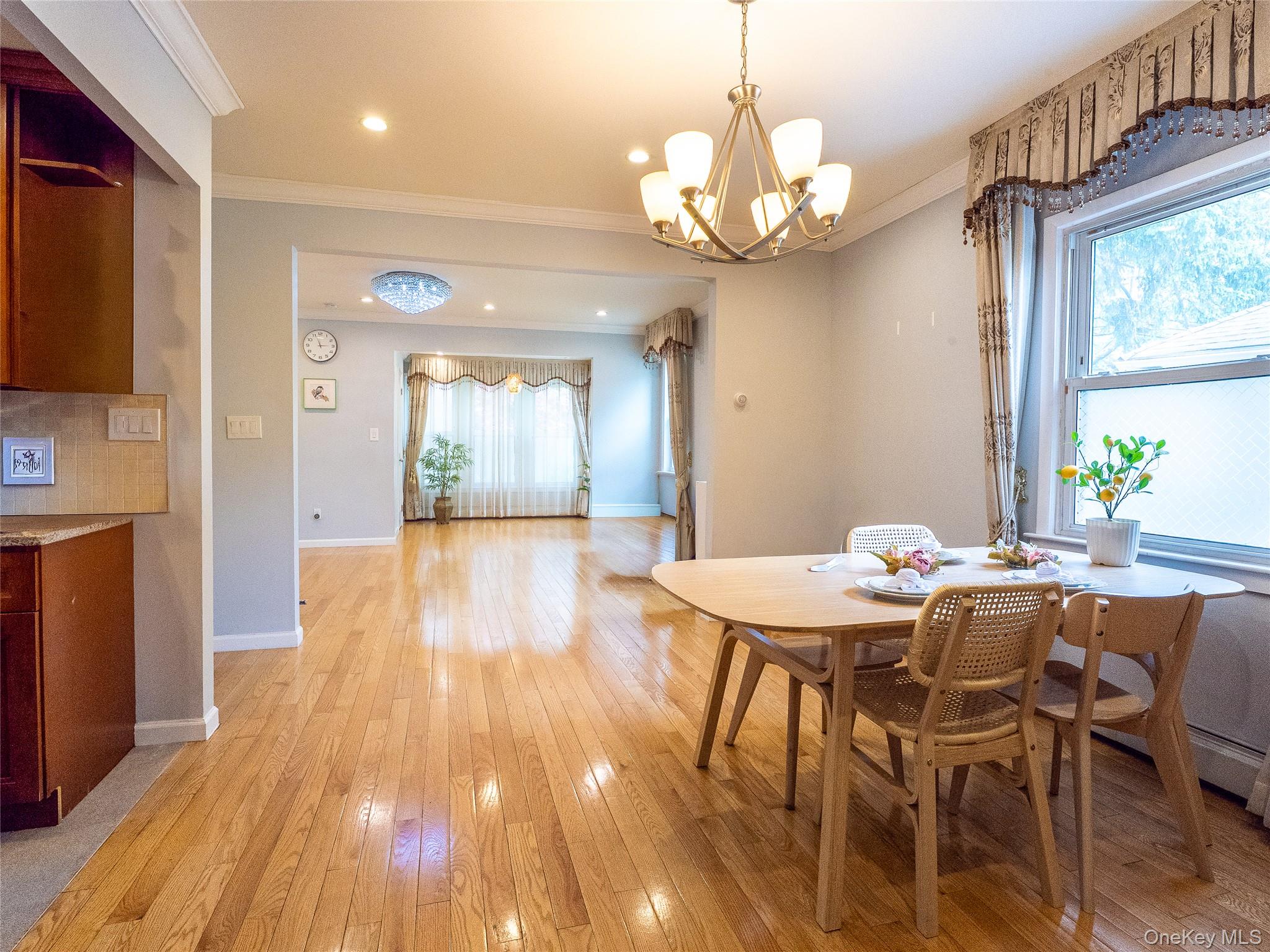45-32 Westminster Road Great Neck, NY 11020 - Photo 9 of 21 a view of a dining room with furniture a chandelier and wooden floor