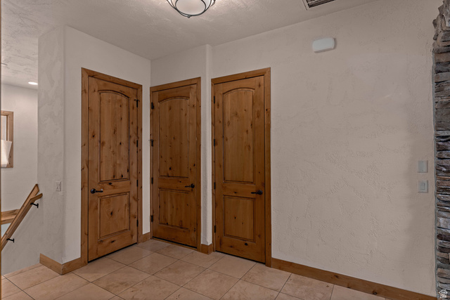 2464 East Granite Way St. George, UT 84790 - Photo 58 of 106 Garage foyer/mudroom entrance featuring baseboards and light tile patterned flooring