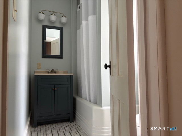 41 Maple Avenue Norfolk, CT 06058 - Photo 7 of 8 a bathroom with a vanity and a mirror