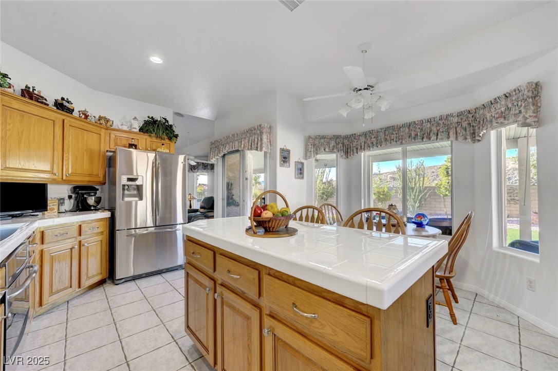 770 Fairway Drive Boulder City, NV 89005 - Photo 23 of 61 Kitchen with tile countertops, stainless steel appliances, light tile patterned flooring, brown cabinets, and recessed lighting