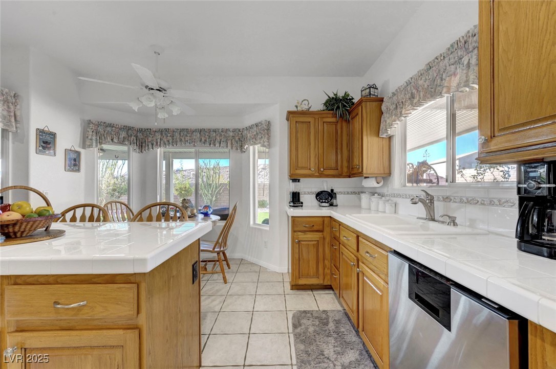 770 Fairway Drive Boulder City, NV 89005 - Photo 24 of 61 Kitchen with tile countertops, dishwasher, light tile patterned floors, and plenty of natural light