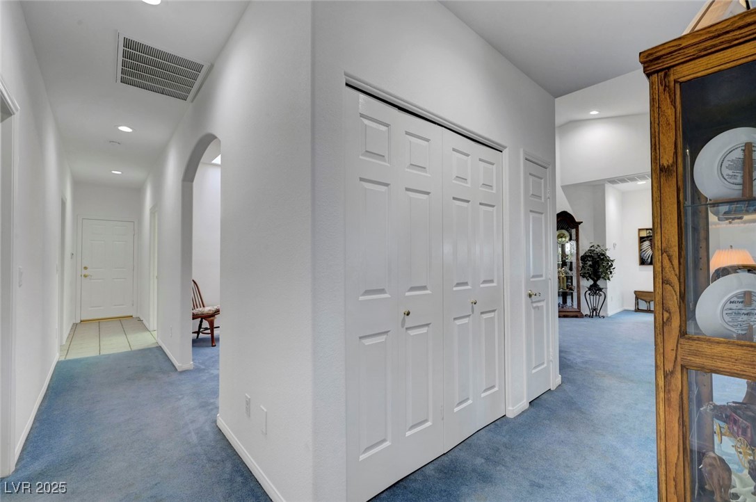 770 Fairway Drive Boulder City, NV 89005 - Photo 27 of 61 Hallway with arched walkways, carpet, and recessed lighting