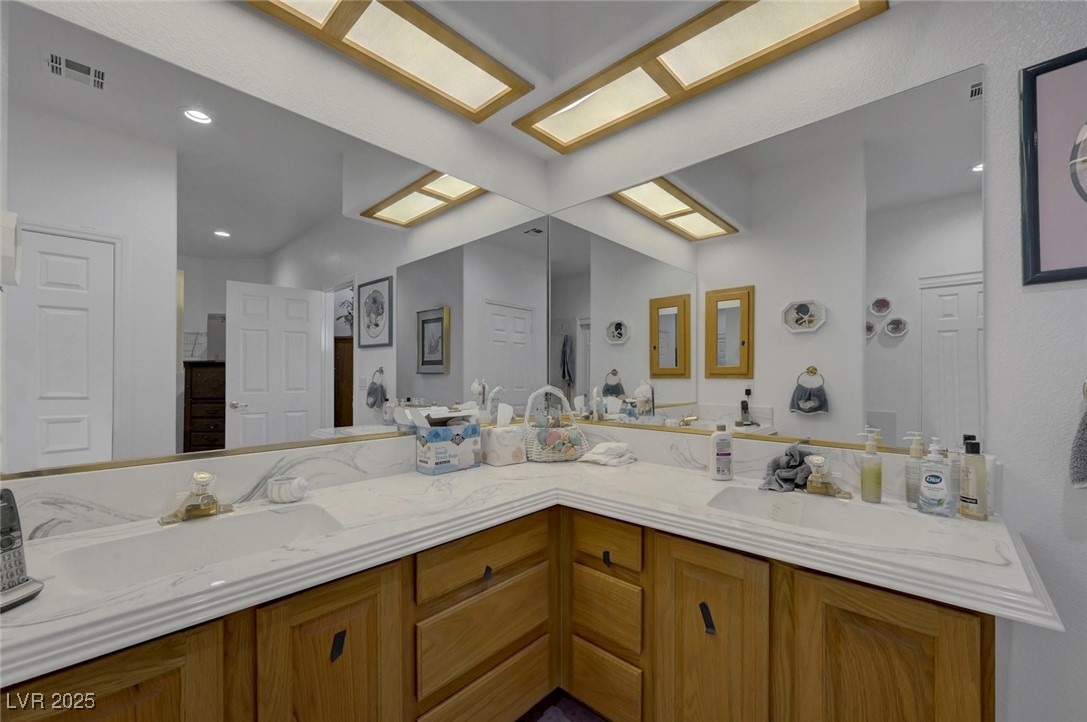 770 Fairway Drive Boulder City, NV 89005 - Photo 35 of 61 Full bathroom featuring double vanity, recessed lighting, and a skylight