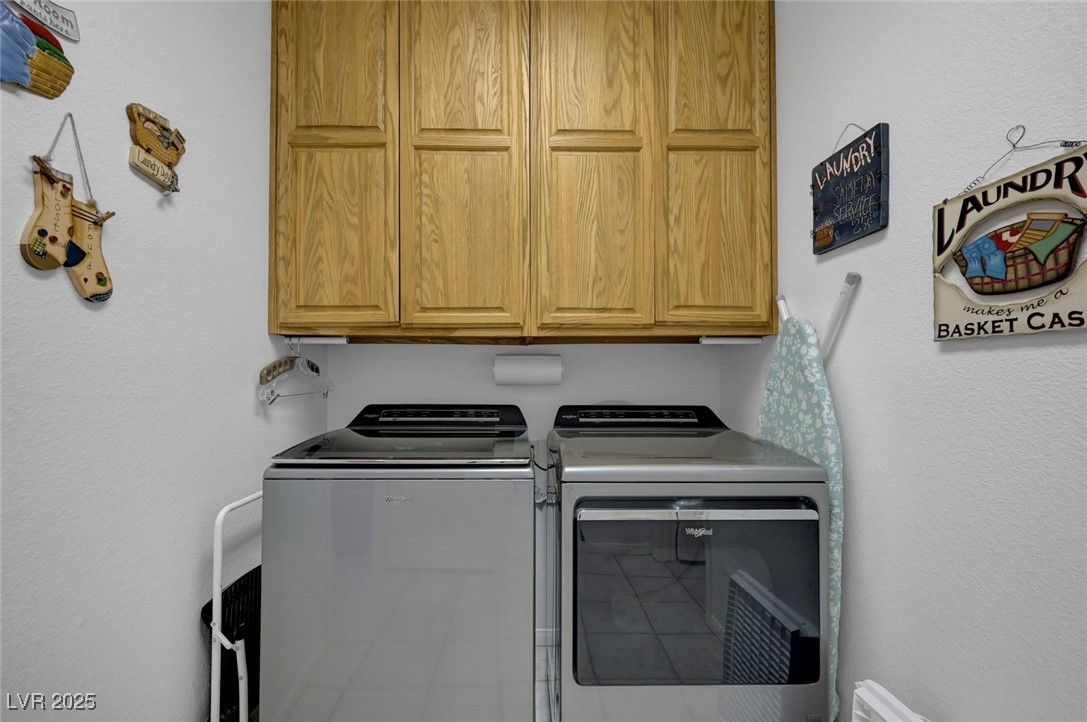 770 Fairway Drive Boulder City, NV 89005 - Photo 38 of 61 Laundry area with a textured wall, washer and clothes dryer, and cabinet space