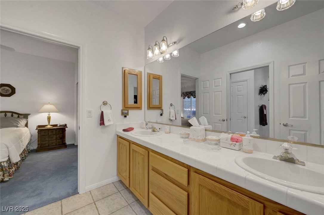 770 Fairway Drive Boulder City, NV 89005 - Photo 45 of 61 Ensuite bathroom featuring light carpet, double vanity, and light tile patterned floors
