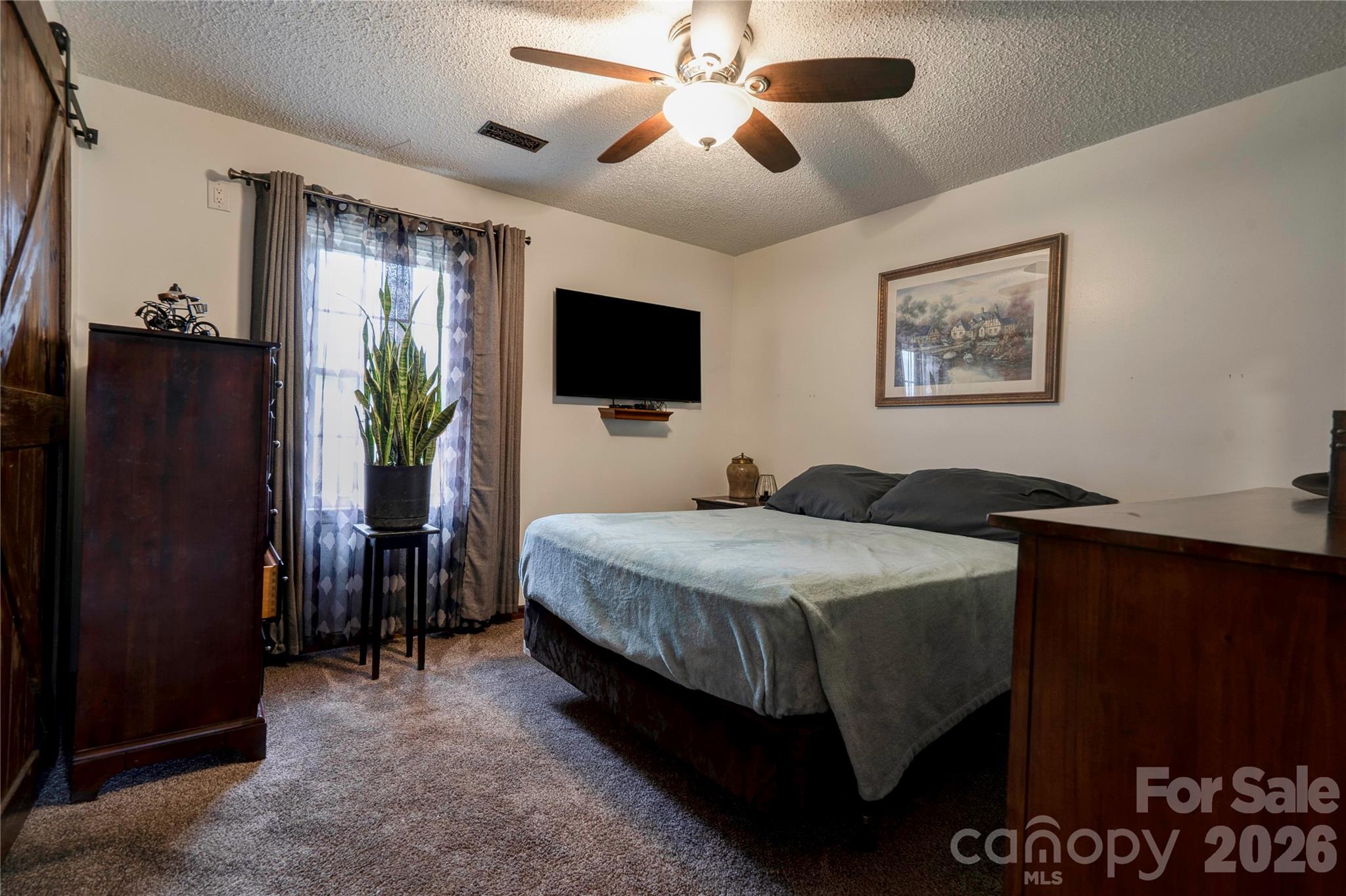 111 Hicks Road Grover, NC 28073 - Photo 14 of 35 a bedroom with a bed and a flat tv screen