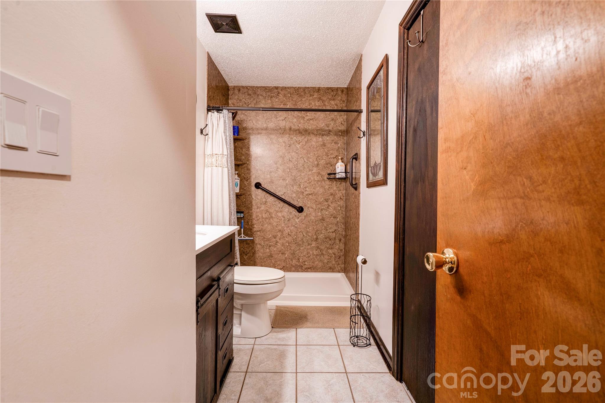 111 Hicks Road Grover, NC 28073 - Photo 19 of 35 a bathroom with a granite countertop shower and a toilet