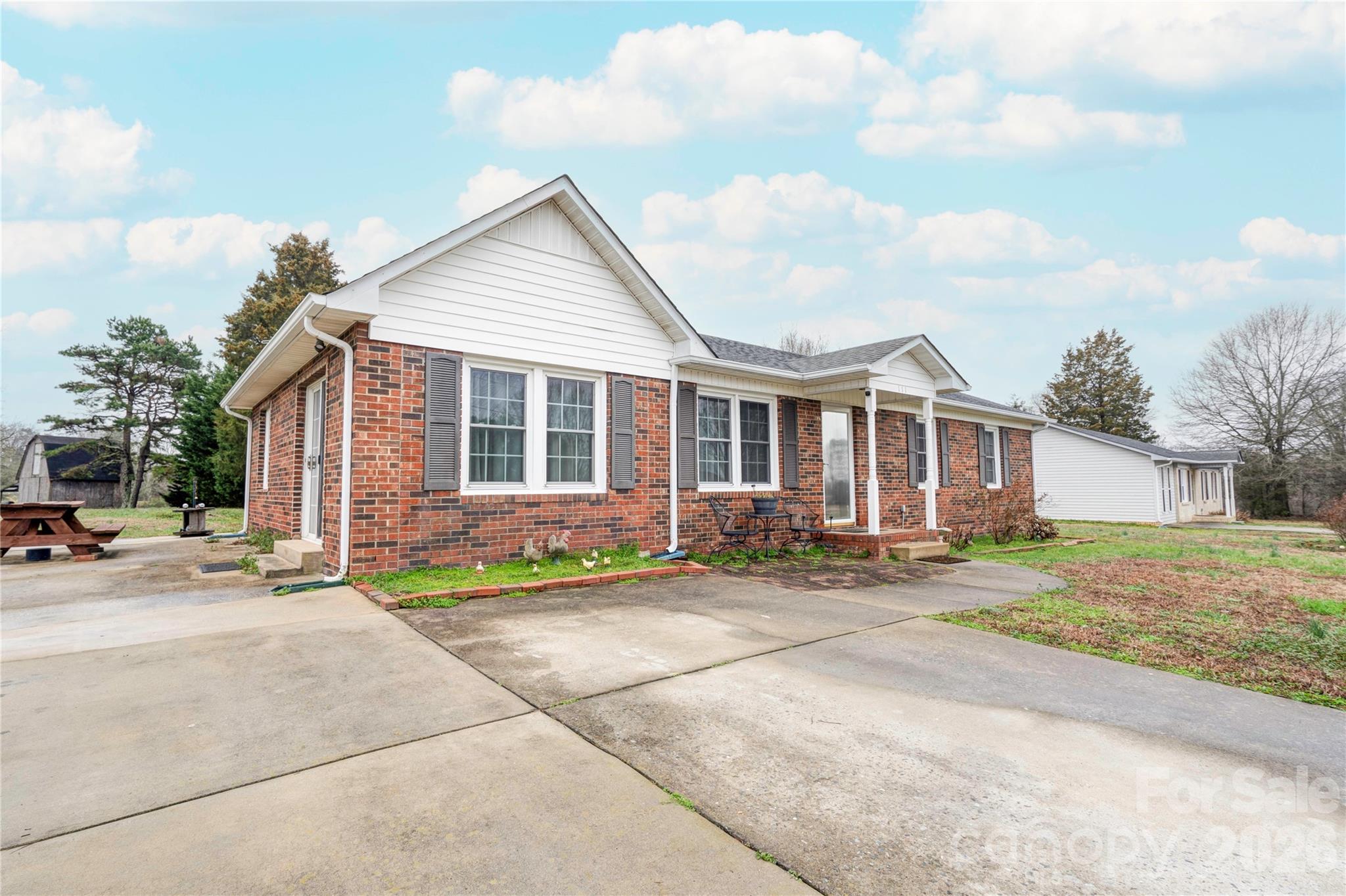 111 Hicks Road Grover, NC 28073 - Photo 2 of 35 a front view of a house with a garden and seating space