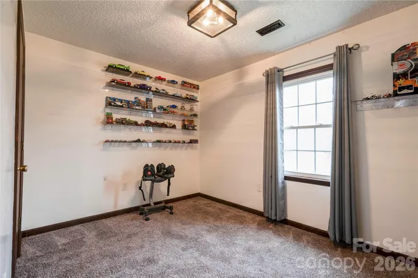 a view of room with window and wooden floor