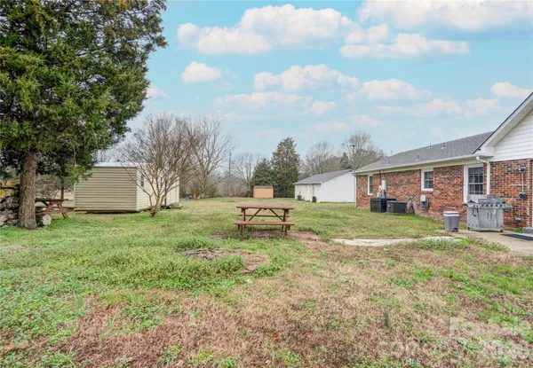a view of a house with a yard and sitting area