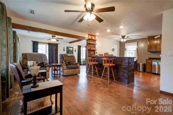 a view of a dining room with furniture wooden floor and chandelier