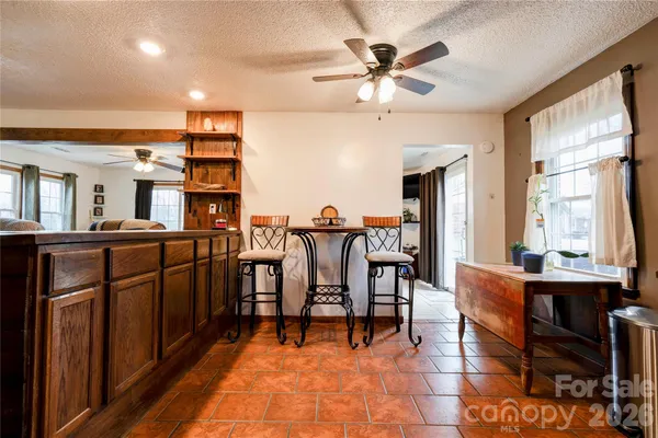 a view of a a dining room with furniture window and wooden floor