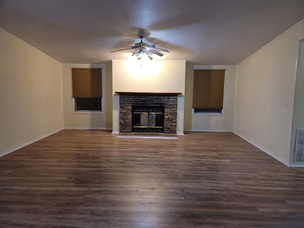 8922 Witter Lane Temple, TX 76502 - Photo 3 of 15 wooden floor fireplace and natural light in empty room