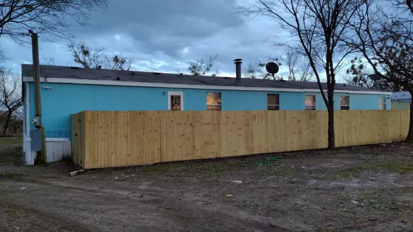 a view of a house with a backyard