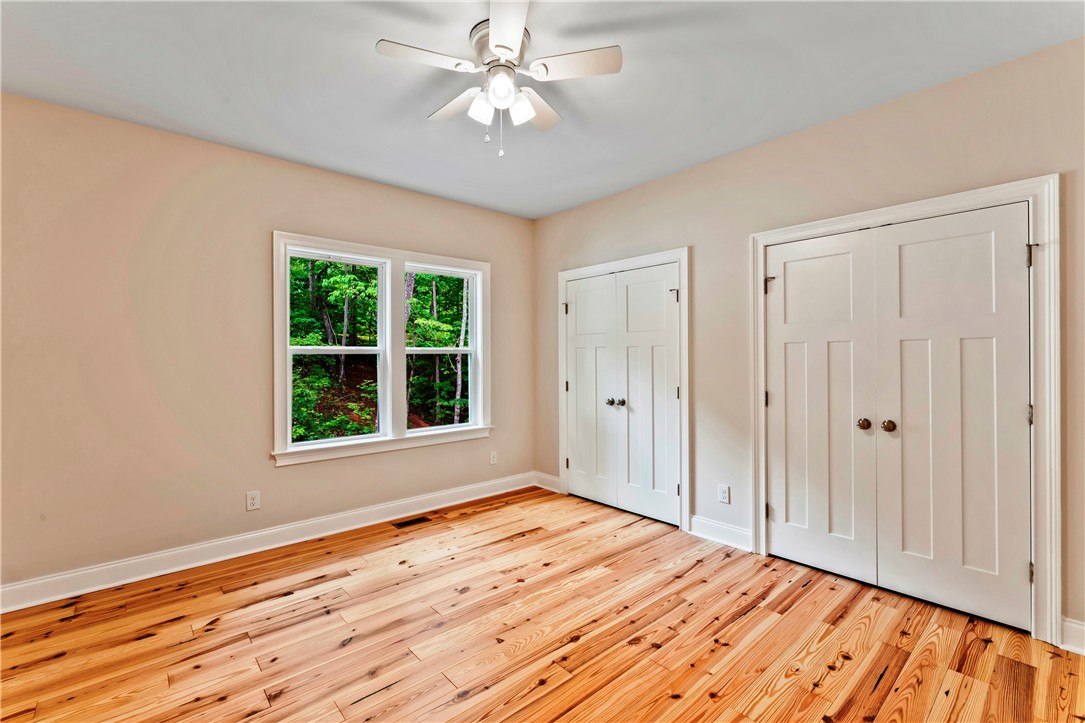 110 Gabriel Way Pickens, SC 29671 - Photo 23 of 48 Natural wood floors and dual windows frame verdant outdoor views in this inviting chamber.