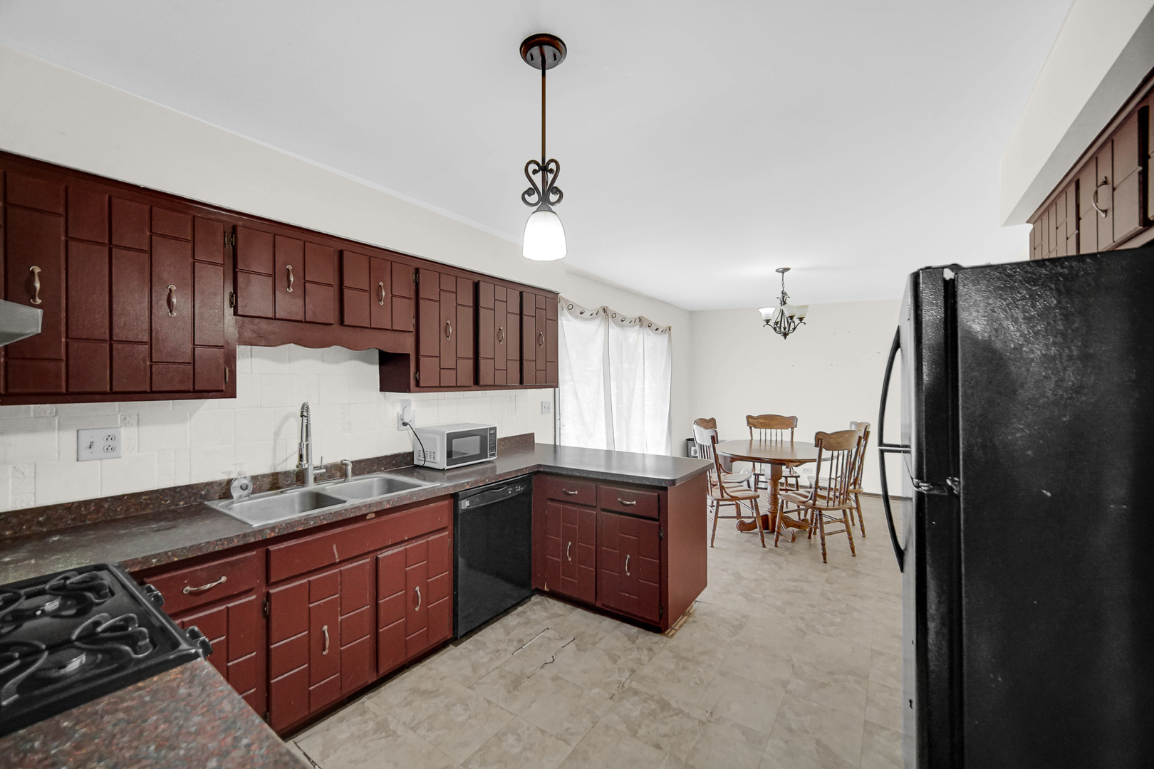 3519 Arthur Road Crete, IL 60417 - Photo 2 of 17 a kitchen with granite countertop wooden cabinets and stainless steel appliances