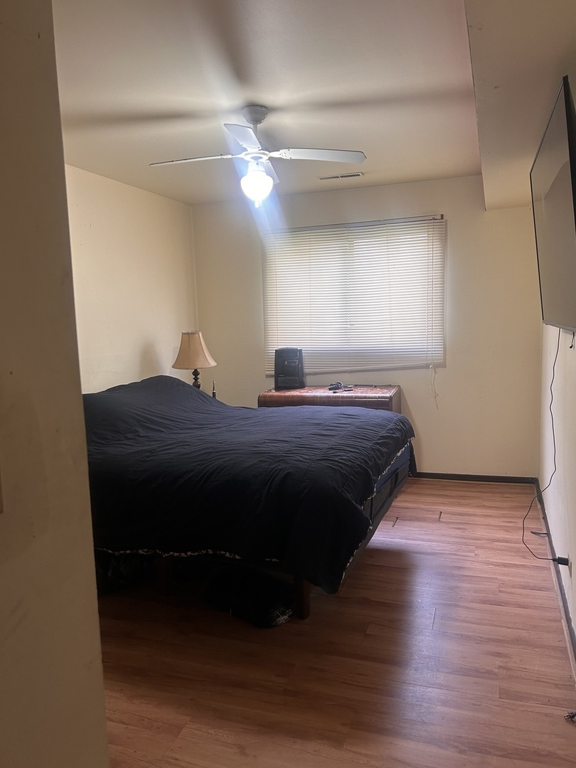 3519 Arthur Road Crete, IL 60417 - Photo 7 of 17 a bed sitting in a room next to a window