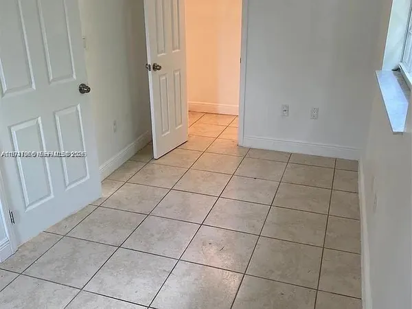 a view of a livingroom with an empty space and a window