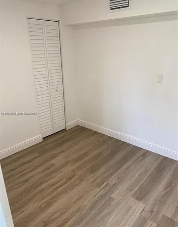 a view of a small space with wooden floor