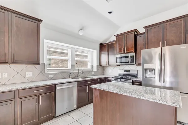 a kitchen with a counter top and cabinetry