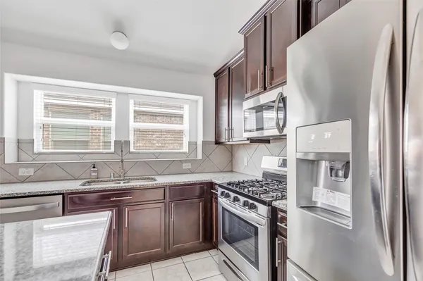 a view of wooden floor and a chandelier fan in a room