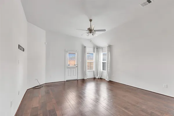 a view of a kitchen with a sink cabinetry a chandelier and wooden floor