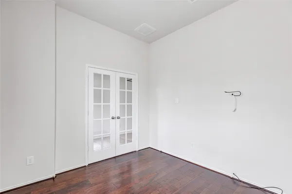 an empty room with wooden floor