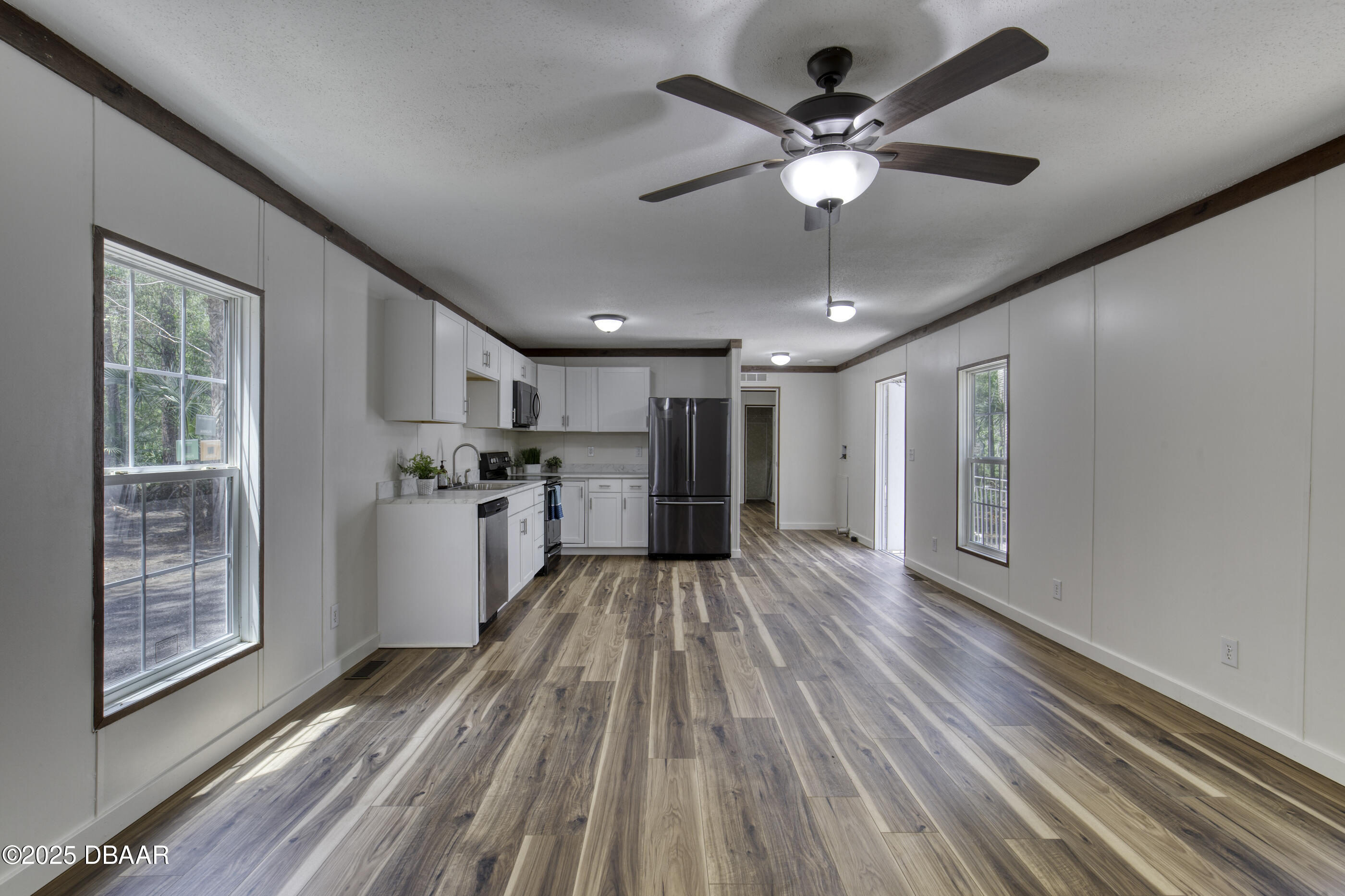 2089 Guava Lane Bunnell, FL 32110 - Photo 16 of 58 a view of an empty room with wooden floor and a window
