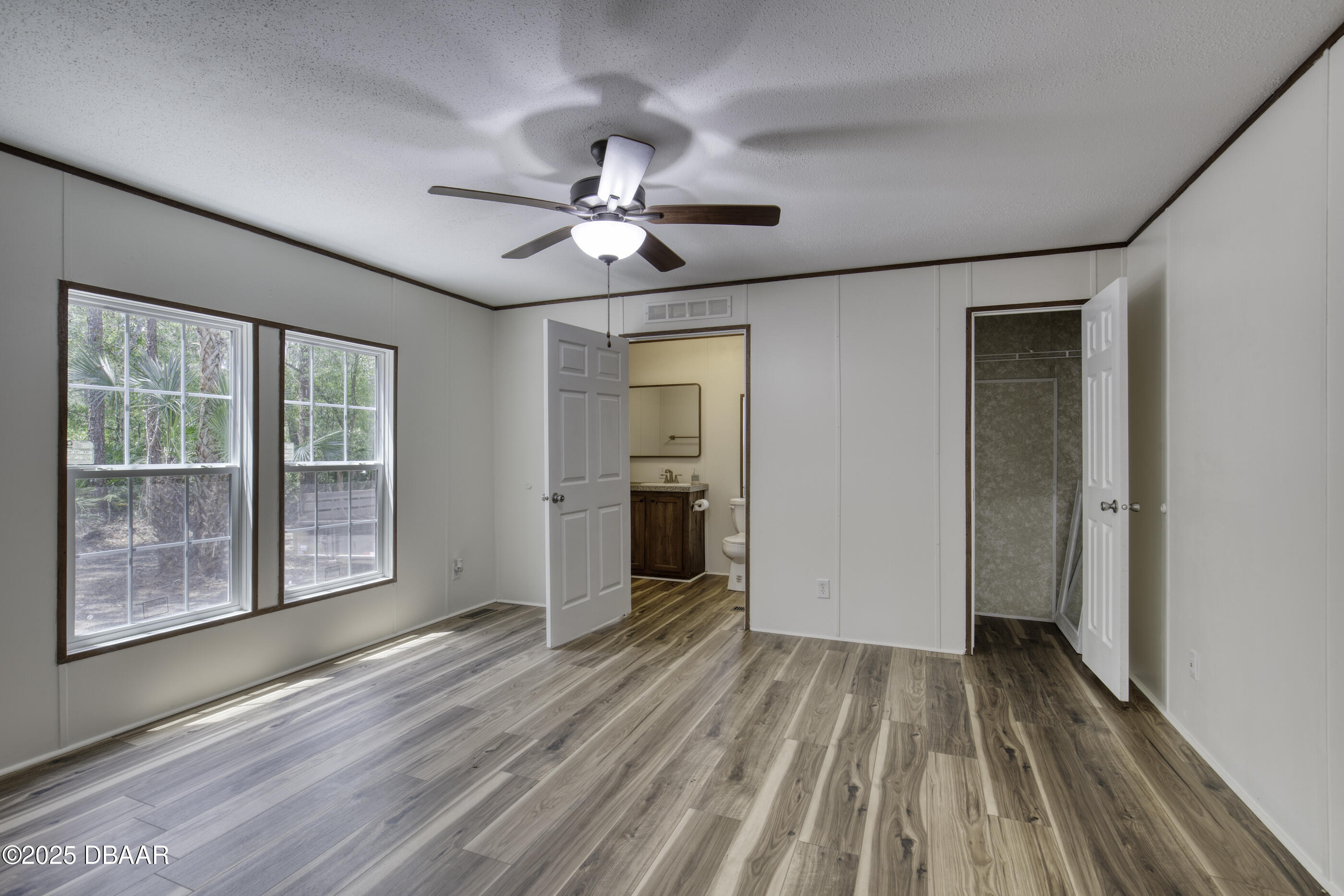 2089 Guava Lane Bunnell, FL 32110 - Photo 23 of 58 a view of empty room with wooden floor and fan