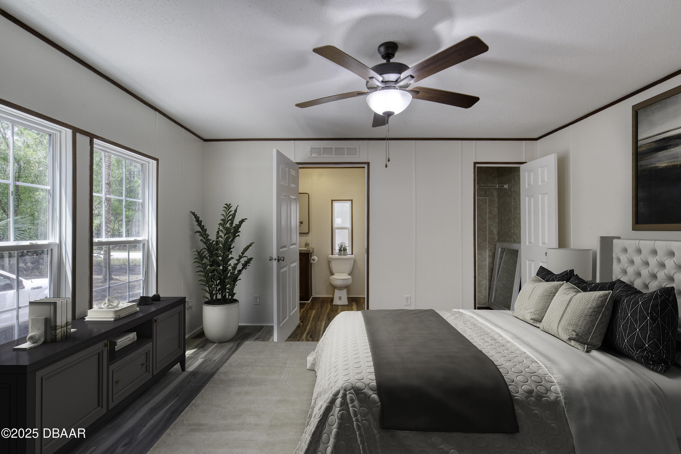 2089 Guava Lane Bunnell, FL 32110 - Photo 26 of 58 a bedroom with a large bed and a chandelier