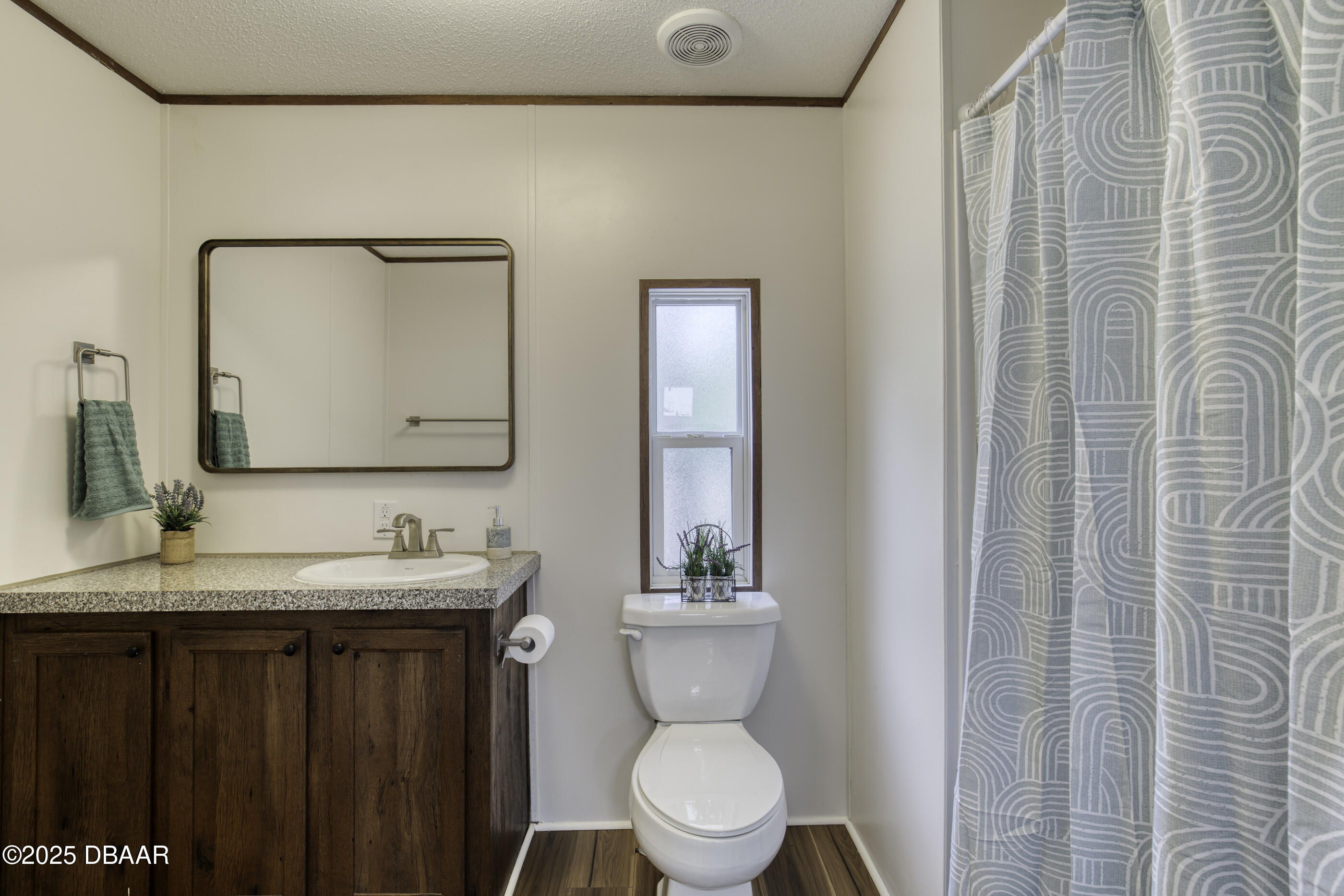 2089 Guava Lane Bunnell, FL 32110 - Photo 28 of 58 a bathroom with a toilet a sink a vanity and mirror
